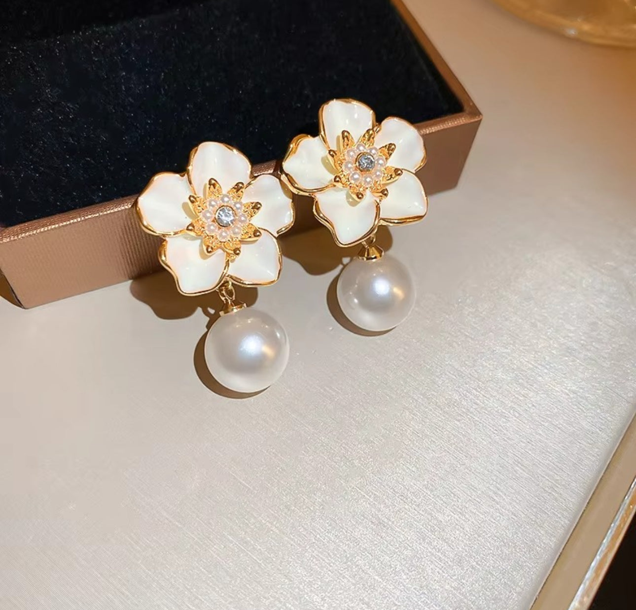 White enamel flower with pearl drop dangler