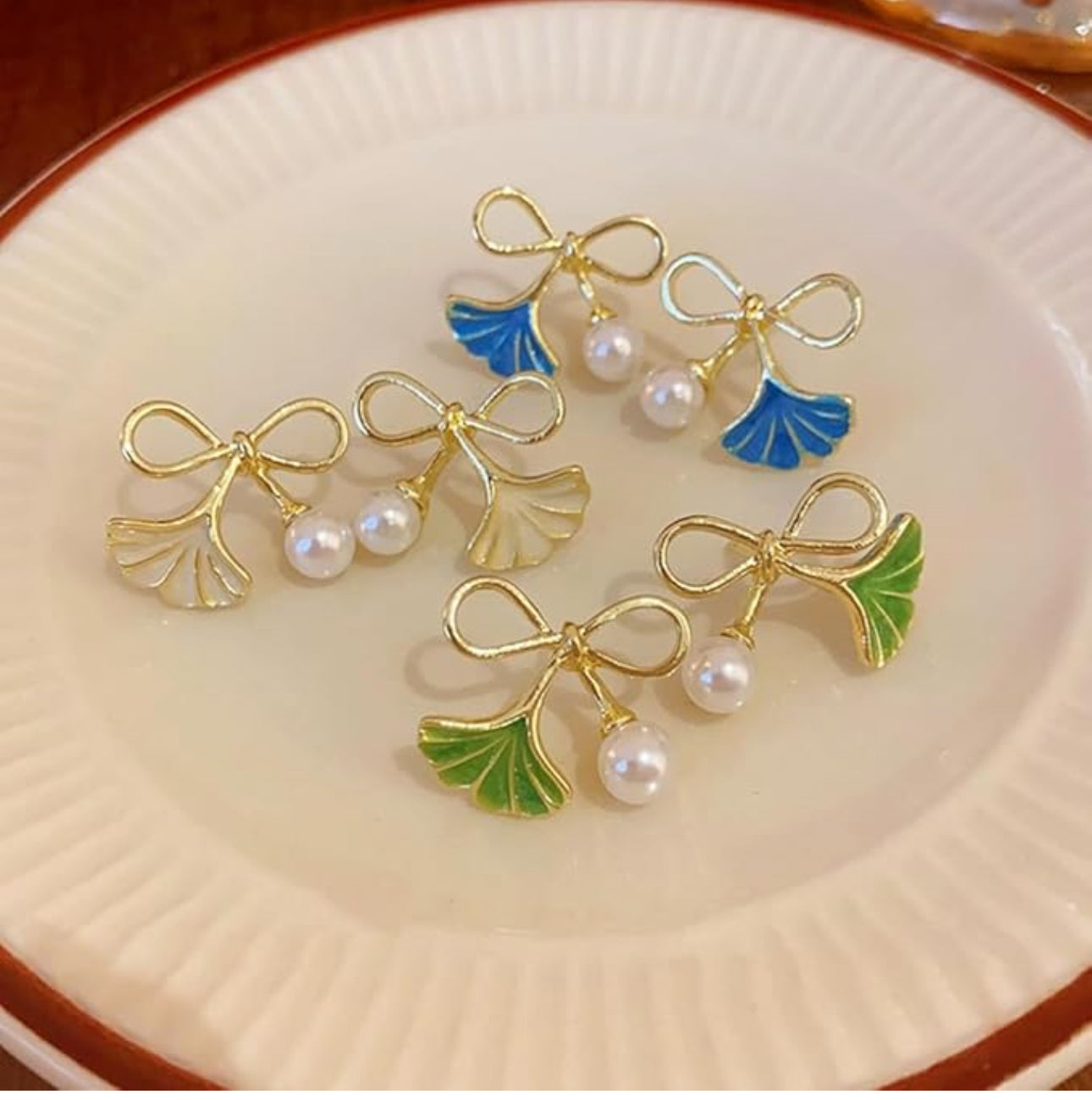 . White Enamel pearl bow ginkgo leaf stud earrings