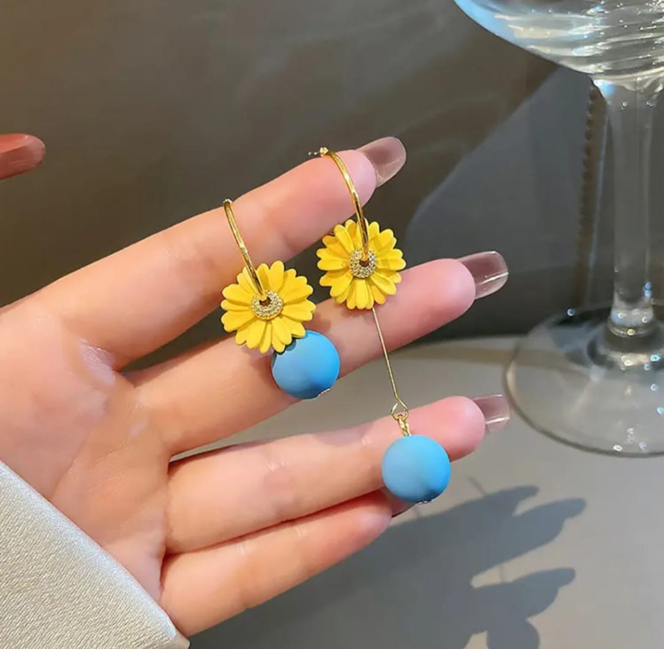 . 2 blue and yellow contrasting earrings