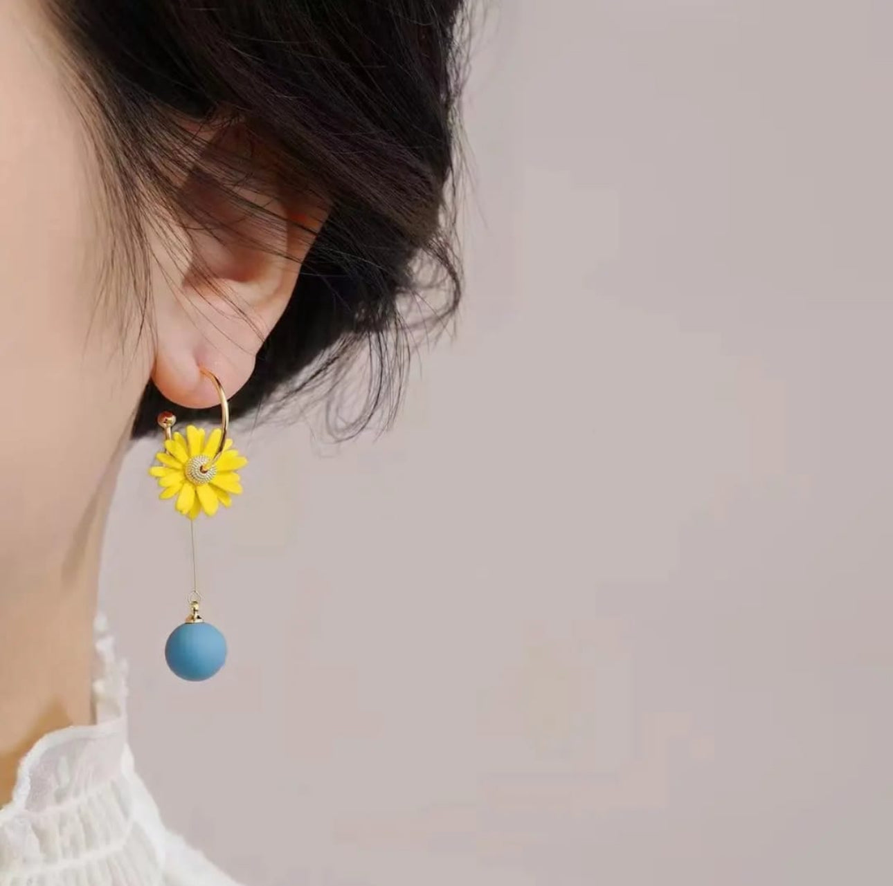 . 2 blue and yellow contrasting earrings