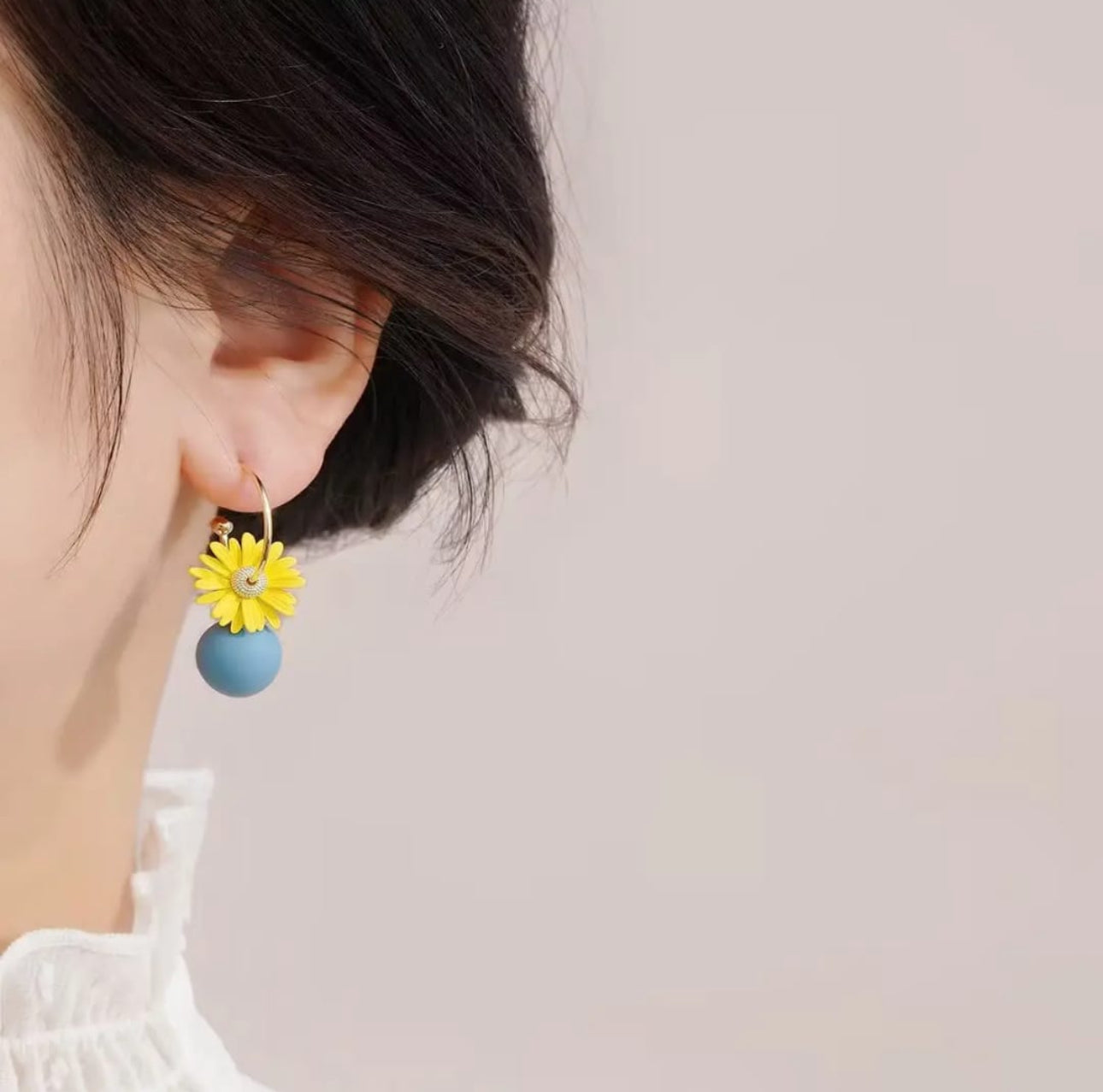 . 2 blue and yellow contrasting earrings